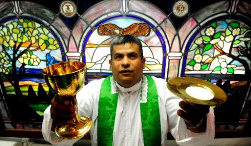 US Navy 110901-N-ZZ999-054 Lt. Jose Bautista Rojas offers the sacraments during a Catholic Mass aboard the Nimitz-class aircraft carrier USS John C