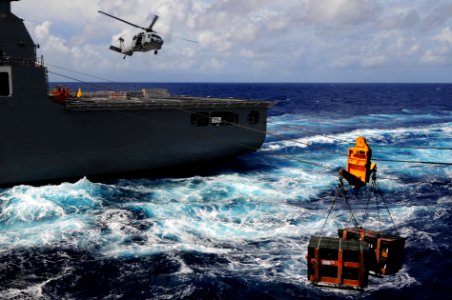 US Navy 110828-N-UO379-055 An MH-60S Sea Hawk helicopter transports ordnance from USS Ronald Reagan (CVN 76) to USNS Charles Drew (T-AKE 10) during