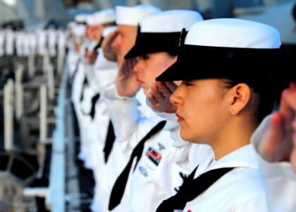 US Navy 110831-N-UO379-242 Sailors and Marines render honors as the aircraft carrier USS Ronald Reagan (CVN 76) passes the USS Arizona Memorial whi