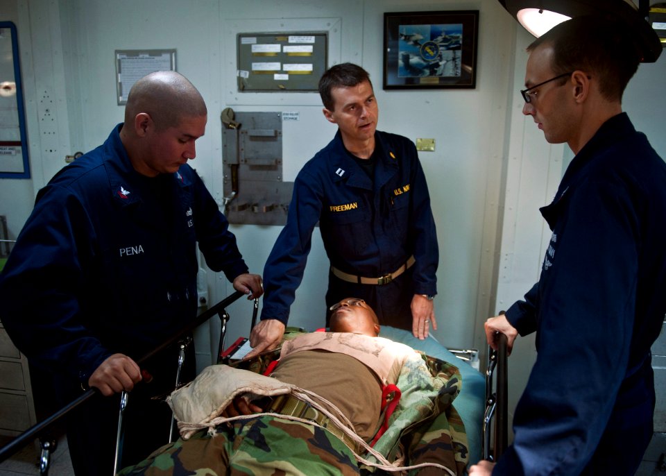 US Navy 110830-N-ZZ999-089 Medical staff members rehearse procedures for treating a chest injury during a mass casualty exercise aboard USS Wasp (L