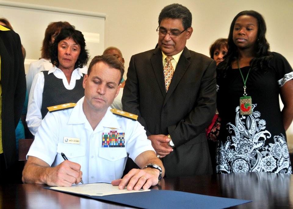US Navy 110901-N-UA460-007 Rear Adm. John C. Jack Scorby Jr. signs a suicide prevention proclamation in front of members of the Navy Region Southea