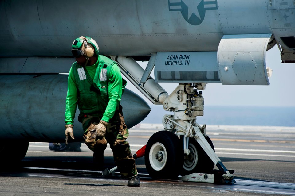 US Navy 110902-N-BT887-381 A Sailor runs to the safety line after finishing pre-flight checks on an F-A-18F Super Hornet aboard USS John C. Stennis