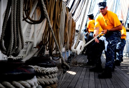 US Navy 110829-N-KB563-214 Chief (select) Aviation Ordnanceman heaves a line aboard the sailing ship Star of India, part of the San Diego Maritime photo