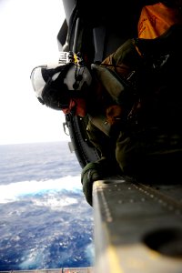 US Navy 110830-N-ZZ999-279 Naval Air Crewman 2nd Class Aaron Hill, from Columbus, Ohio, looks out the cabin of an MH-60S Sea Hawk helicopter