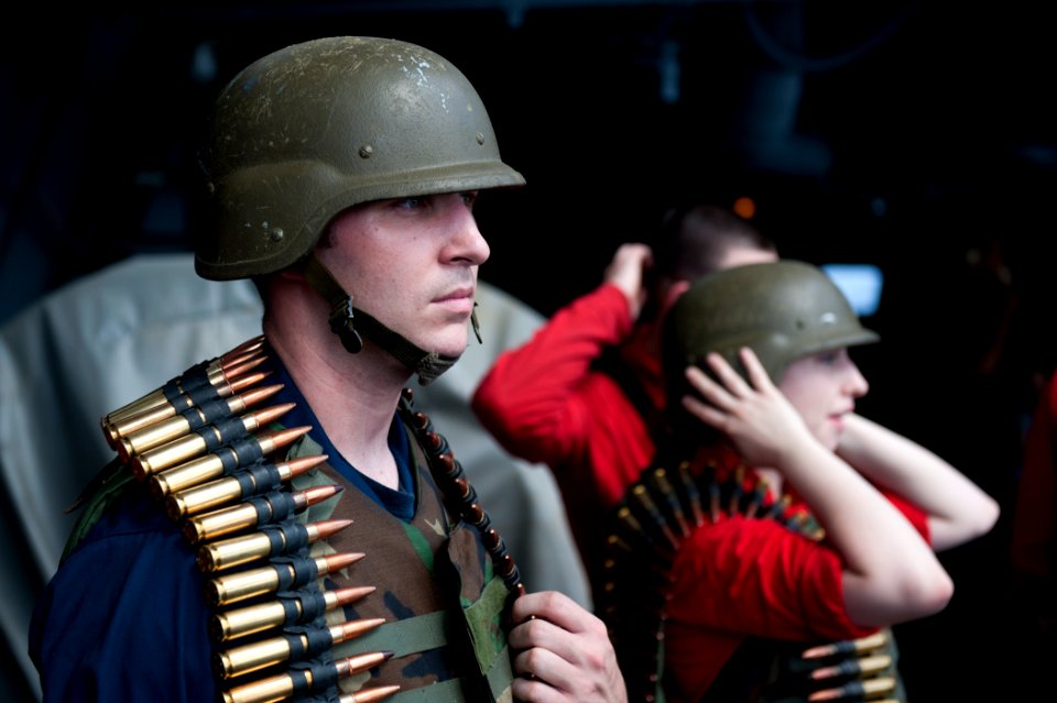 US Navy 110831-N-BT887-005 Aviation Ordnanceman Airman Scott Segel, from Antioch, Ill., waits to fire a .50-caliber machine gun aboard the Nimitz-c