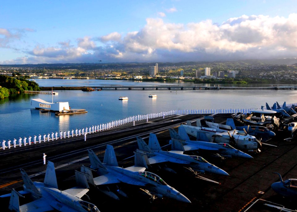 US Navy 110831-N-EE987-351 Sailors and Marines render honors as the aircraft carrier USS Ronald Reagan (CVN 76) passes the USS Arizona Memorial