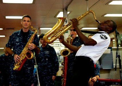 US Navy 110829-N-RM525-138 A Haitian Police Band member plays the saxophone with U.S. Fleet Forces Band aboard USNS Comfort (T-AH 20) during Contin photo