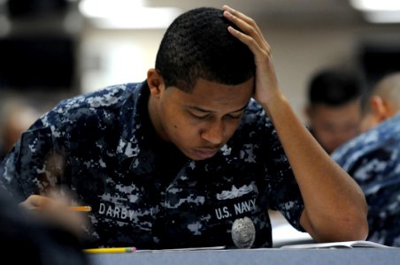 US Navy 110901-N-XG305-052 Master-at-Arms 2nd Class Terrance Darby takes the first class petty officer advancement exam on the mess decks