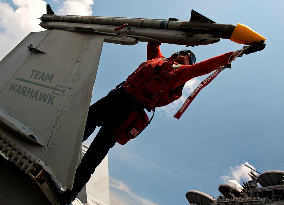 US Navy 110902-N-BT887-329 Aviation Ordnanceman 2nd Class Stephen Bailey places a cap on a missile on an F-A-18C Hornet