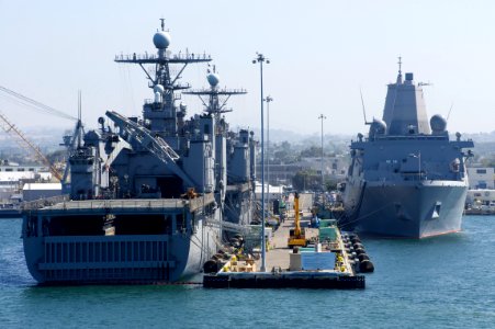 US Navy 110831-N-ZC343-617 The amphibious dock landing ships USS Pearl Harbor (LSD 52) and USS Rushmore (LSD 47) share a pier with the amphibious t photo