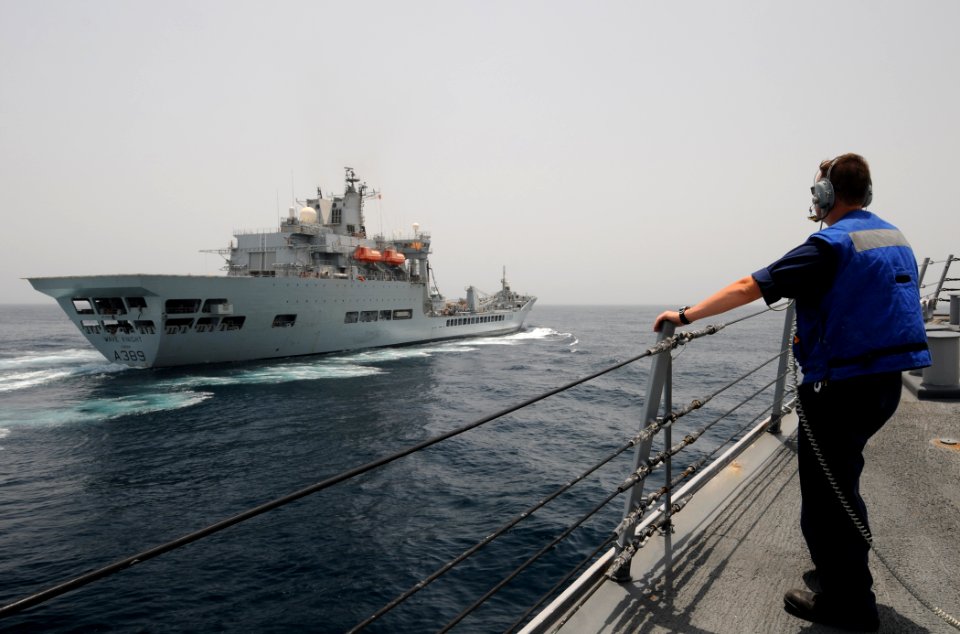 US Navy 110904-N-XQ375-247 Sonar Technician 3rd Class John Wessel observes from the foc'sle of the guided-missile destroyer USS Mitscher (DDG 57)