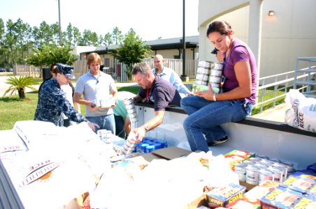 US Navy 110831-N-UT935-575 Civilians and Sailors assigned to the John C. Stennis Space Center load nearly a ton of food