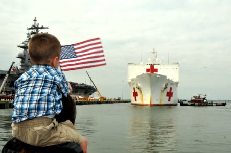US Navy 110902-N-QY430-058 Family and friends look on as the Military Sealift Command hospital ship USNS Comfort (T-AH-20) arrives at Naval Station photo