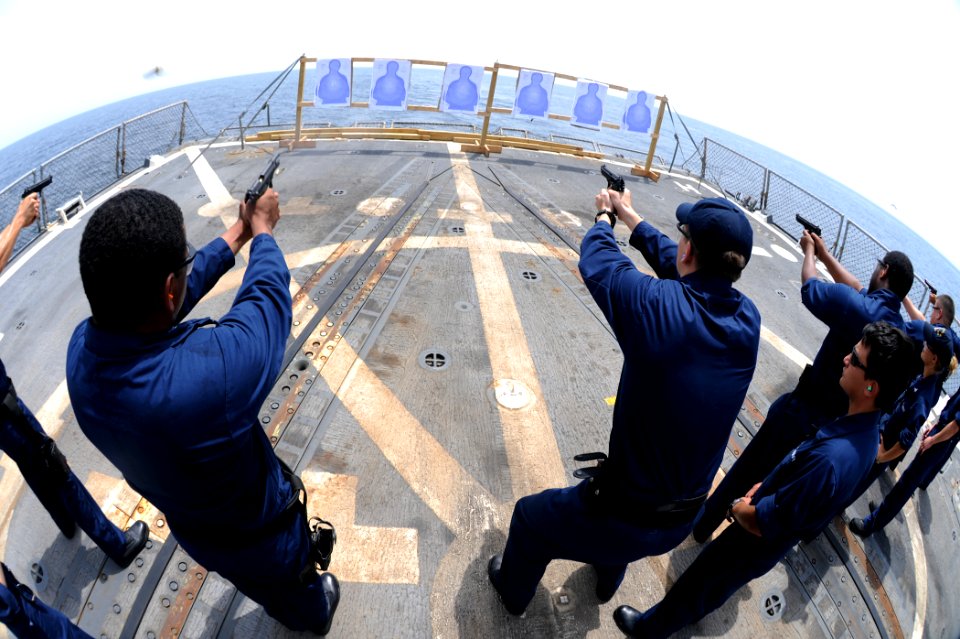 US Navy 110831-N-YZ751-119 Sailors fire 9mm pistols during a weapons qualification aboard the guided-missile destroyer USS Truxtun (DDG 103)