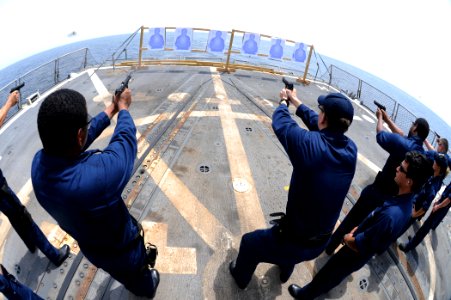 US Navy 110831-N-YZ751-119 Sailors fire 9mm pistols during a weapons qualification aboard the guided-missile destroyer USS Truxtun (DDG 103)