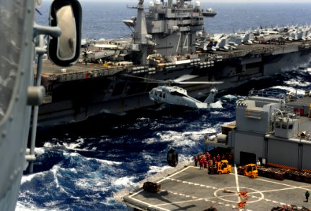 US Navy 110830-N-ZZ999-347 An MH-60S Sea Hawk helicopter from the Eightballers of Helicopter Sea Combat Squadron (HSC) 8 transfers cargo during a