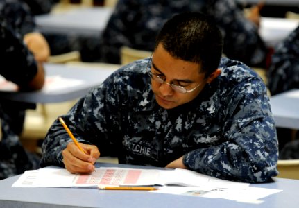 US Navy 110901-N-XG305-050 Logistics Specialist 2nd Class Fernado Putchie takes the first class petty officer advancement exam on the mess decks ab