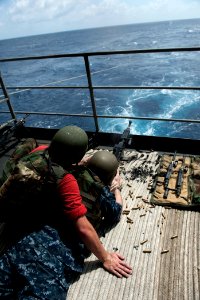 US Navy 110831-N-BT887-176 Chief (Sel.) Aviation Ordnanceman Alex Bates fires an M240 machine gun as Gunner's Mate 2nd Class Phillip Grauer observe