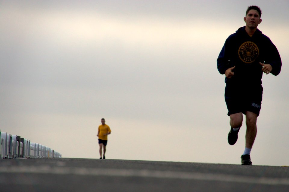 US Navy 110904-N-ZC343-819 Sailors assigned to the amphibious assault ship USS Bonhomme Richard (LHD 6) run on the flight deck during the executive