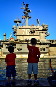US Navy 110831-N-RI844-062 Friends and family members of Sailors aboard Nimitz-class aircraft carrier USS Ronald Reagan (CVN 76) wave as the ship e photo