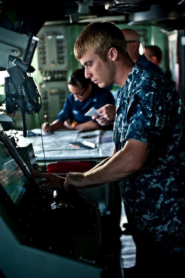 US Navy 110906-N-DX615-025 Seaman Floyd Taylor changes the ship's speed during a strait transit navigation exercise