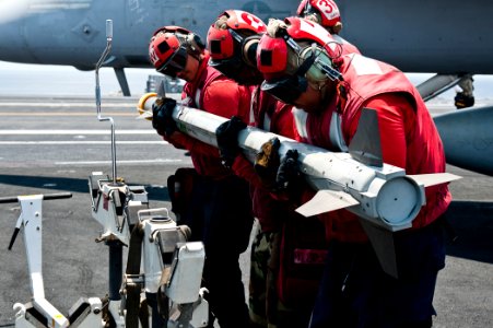 US Navy 110902-N-BT887-338 Sailors places ordnance on a dolly for transport aboard USS John C. Stennis (CVN 74)
