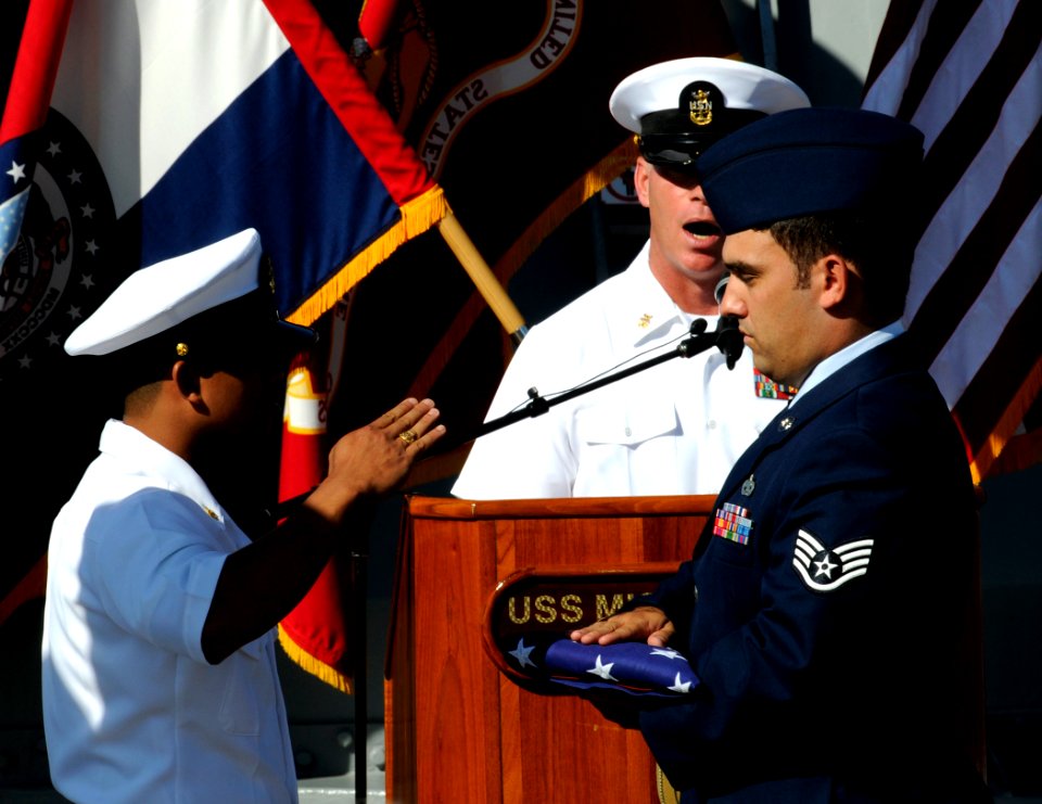 US Navy 110902-N-VM928-074 A chief petty officer and airman pass the American flag during the reading of Old Glory during the 66th anniversary of t