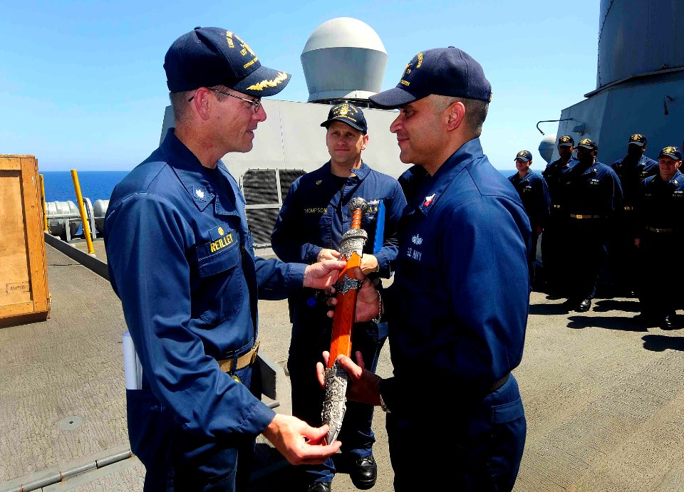 US Navy 110901-N-CT127-027 Cmdr. John K. Reilley presents the Centurion Award to Information Systems Technician 1st Class Victor Figueroa for achie