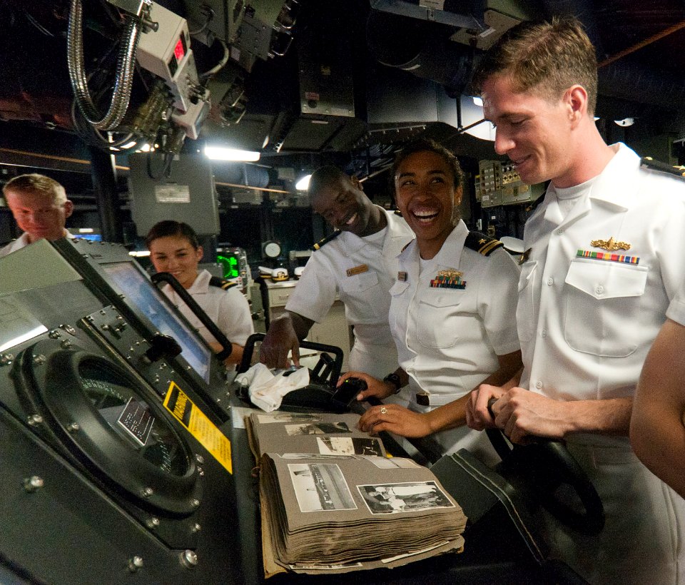 US Navy 110906-N-TB118-118 Junior officers aboard (PCU) Spruance (DDG 111) look through a photo album of the ship's namesake, Adm. Raymond Spruance