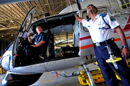 US Navy 110906-N-IZ292-230 Aviation Electrician's Mate 2nd Class Christopher Lloyd watches Inspector Harendre Ramful operate a rescue hoist during