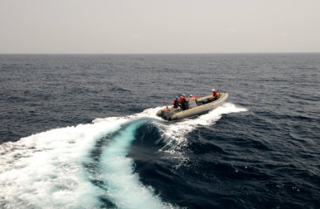 US Navy 110906-N-XQ375-116 Sailors assigned to guided-missile destroyer USS Mitscher (DDG 57) transfer personnel in a rigid-hull inflatable boat to photo