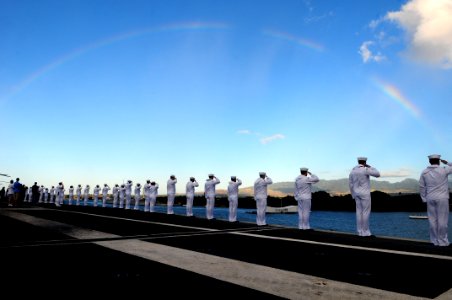 US Navy 110903-N-UO379-173 Sailors and Marines render honors as USS Ronald Reagan (CVN 76) passes the USS Arizona Memorial while departing Pearl H