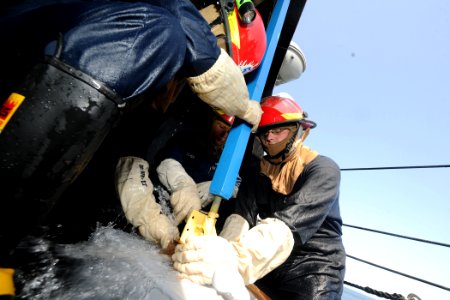 US Navy 110902-N-YZ751-040 Sailors patch a simulated rupture in the deck during a damage control exercise aboard the guided-missile destroyer USS T