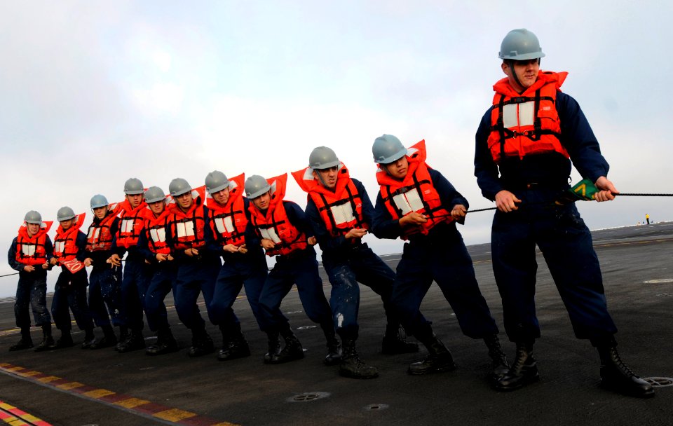 US Navy 110907-N-GZ277-034 Sailors assigned to deck department handle the phone and distance line during a refueling at sea aboard the Nimitz-class