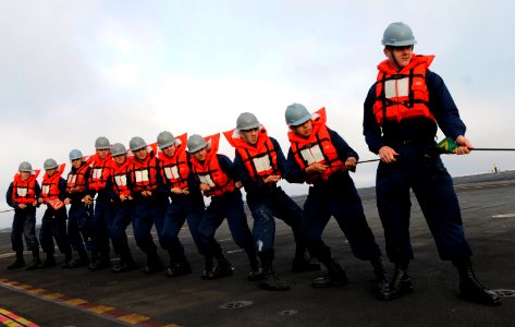 US Navy 110907-N-GZ277-034 Sailors assigned to deck department handle the phone and distance line during a refueling at sea aboard the Nimitz-class