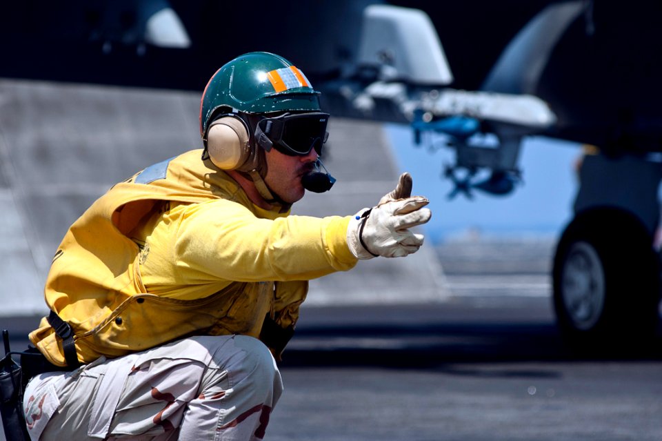 US Navy 110902-N-BT887-413 Lt. Nate Staff gives the launch approval for an F-A-18F Super Hornet aboard USS John C. Stennis (CVN 74)