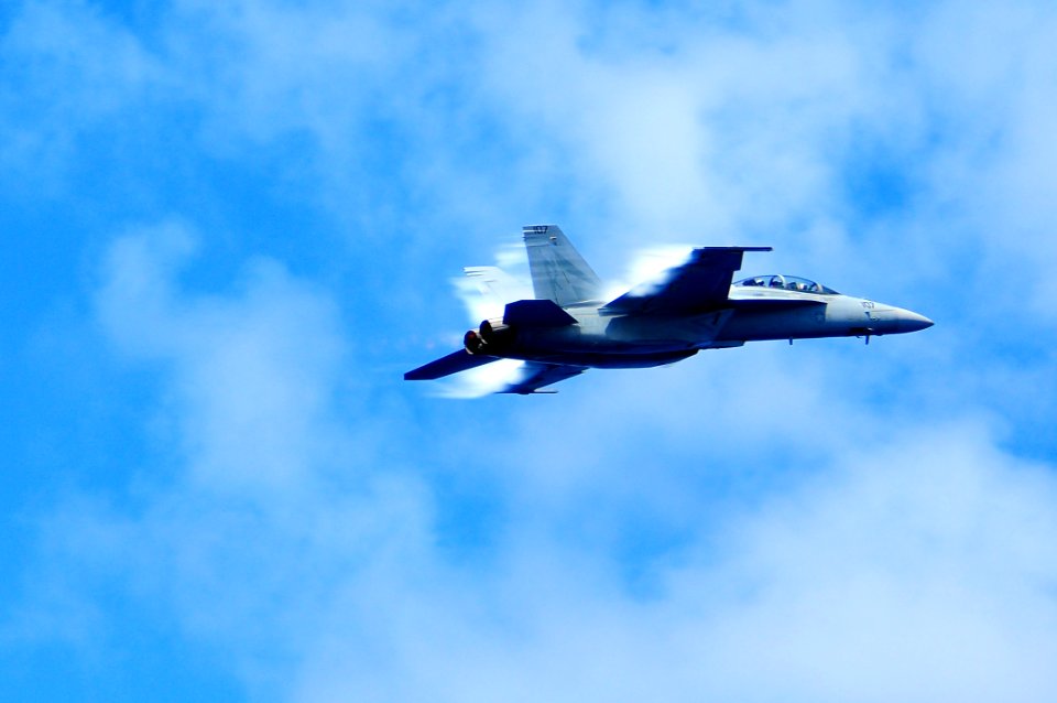 US Navy 110904-N-UO379-466 An F-A-18F Super Hornet makes a supersonic pass over USS Ronald Reagan (CVN 76) during a tiger cruise