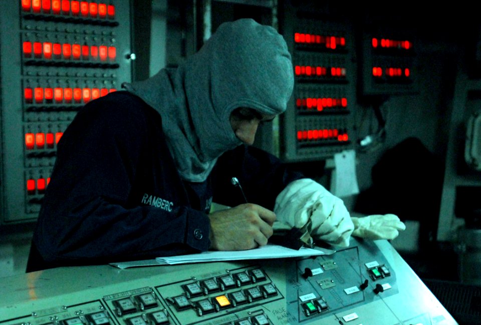 US Navy 110905-N-GH121-011 Hull Technician Fireman Jeremy Ramberg signs the log sheet as central watch in Damage Control Central during a general q