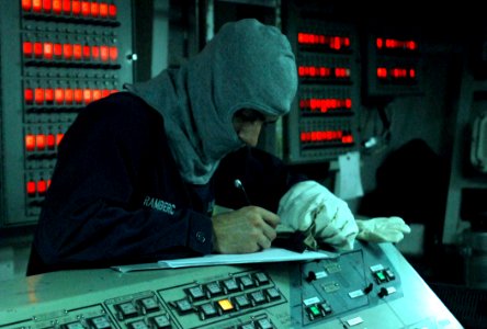 US Navy 110905-N-GH121-011 Hull Technician Fireman Jeremy Ramberg signs the log sheet as central watch in Damage Control Central during a general q
