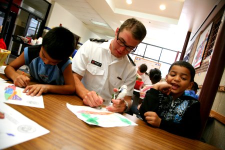 US Navy 110906-N-YM440-141 Midshipman 3rd Class Jonathan Larson, a Navy ROTC member at the University of Nebraska, draws with students at Everett E