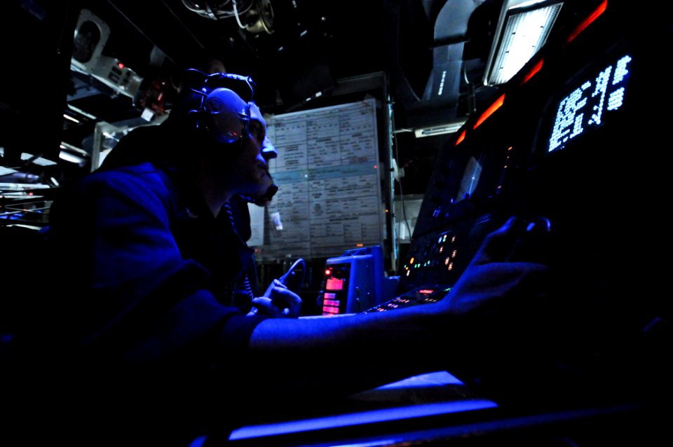 US Navy 110907-N-YM590-038 Fire Controlman 2nd Class Eric Burns prepares to fire the forward MK 45 5-inch lightweight gun from the combat informati