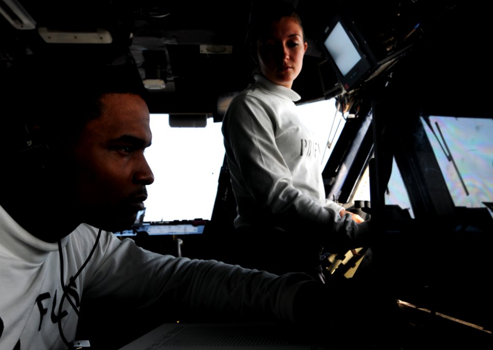 US Navy 110907-N-XE109-123 Aviation Boatswain's Mate (Equipment) Airman Kelsey K. Schrempp, right, reports the launch of an aircraft to Aviation Bo