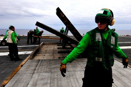 US Navy 110906-N-EE987-004 Aviation Boatswain's Mate Airman Jared Tello sets a safety boundary during a jet blast deflector demonstration drill abo