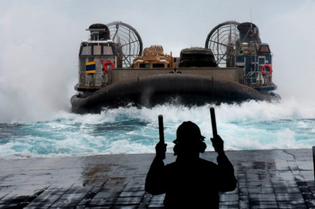 US Navy 110904-N-PB383-124 A Sailor guides a landing craft air cushion (LCAC) as it approaches the amphibious transport dock ship USS New Orleans (