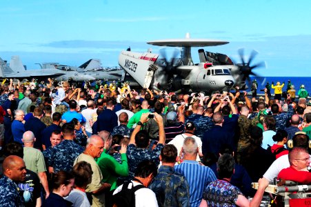 US Navy 110905-N-UO379-066 An E-2C Hawkeye is directed toward a catapult on the flight deck of USS Ronald Reagan (CVN 76) during a tiger cruise air