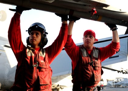 US Navy 110908-N-YC505-132 Aviation Ordnancemen 2nd Class Alexis Berrios, left, and Jon Caldwell load ordnance onto an F-A-18C