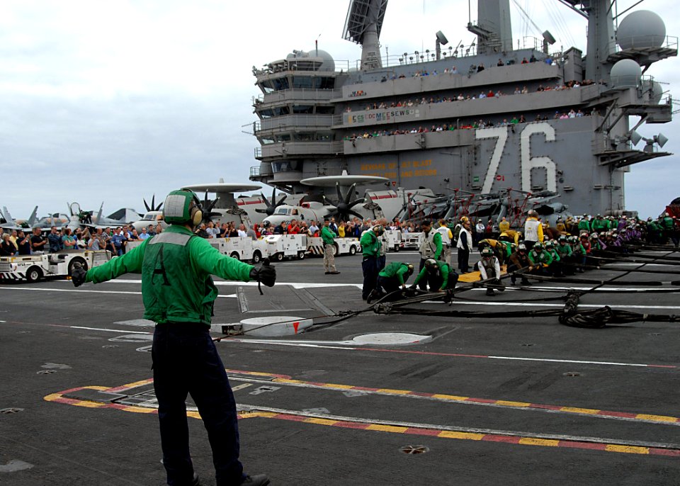 US Navy 110906-N-SG869-255 Friends and family members observe Sailors as they prepare to raise an aircraft barricade during an emergency barricade