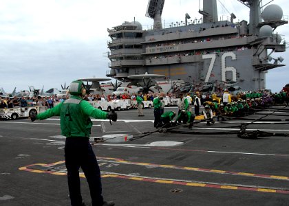 US Navy 110906-N-SG869-255 Friends and family members observe Sailors as they prepare to raise an aircraft barricade during an emergency barricade