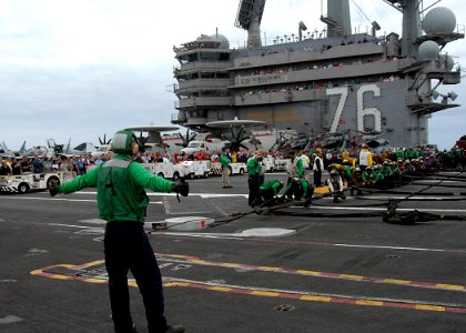 US Navy 110906-N-SG869-255 Friends and family members observe Sailors as they prepare to raise an aircraft barricade during an emergency barricade photo