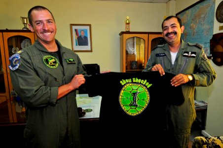 US Navy 110906-N-IZ292-276 Lt. Cmdr. Teague Suarez presents a T-shirt to Wing Cmdr. Misra Shashank during a visit to the MPF Helo Squadron